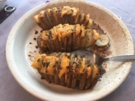 Potatoes covered with melted cheese.