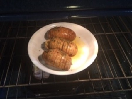 Potatoes in a plate with melted butter.