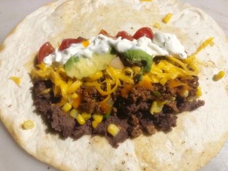 A tortilla filled with ingredients.