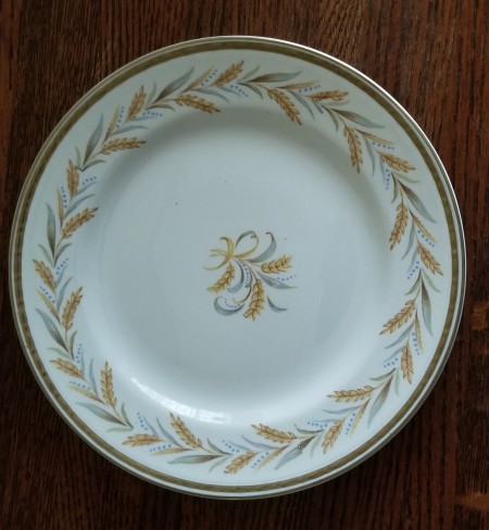 A china plate with a wheat design.