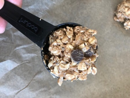 Scooping energy bites onto waxed paper.