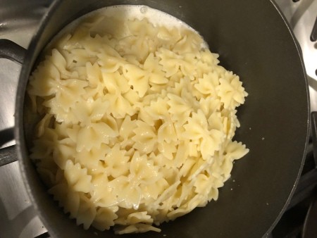 A pan of mini farfalle pasta.
