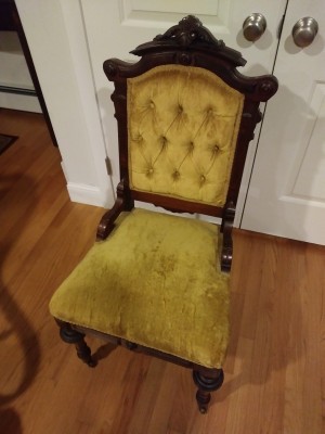 Identifying an Antique Chair? - upholstered chair with ornate back and wheels on front legs