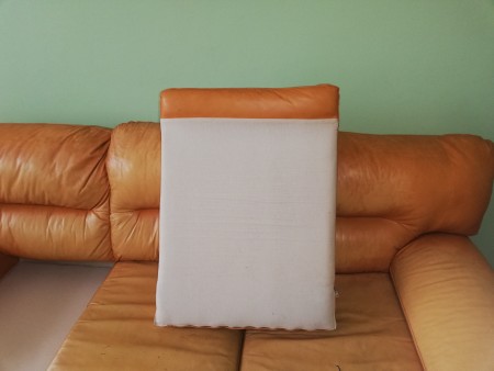 The cushion of a leather sofa.