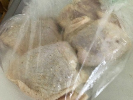 Chicken pieces in a plastic bag.