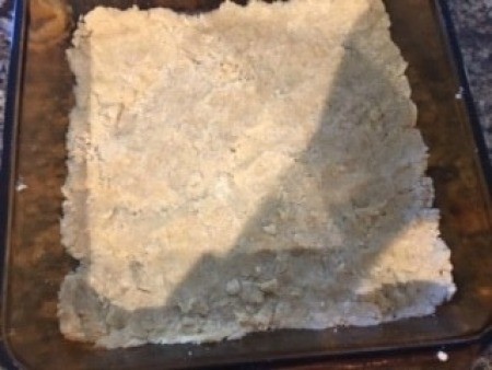 The crust mixture pressed into a baking pan.