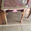 table painted pink and light green with a decorative vinyl top