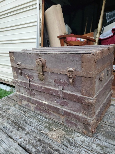 An old trunk with the lid open.