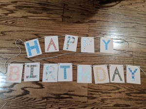 Happy Birthday Cut Letter Banner - finished banner lying on the floor