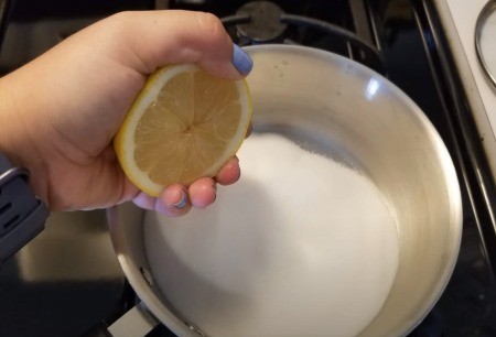 Adding lemon to the sugar.