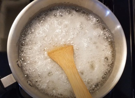 Stirring the boiling sugar wax mixture.