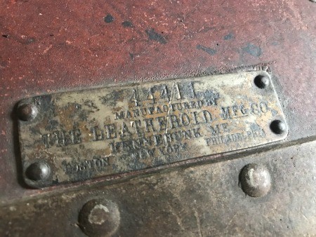 A maker's mark on a wardrobe trunk.