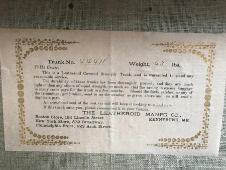 A certificate on a wardrobe trunk.