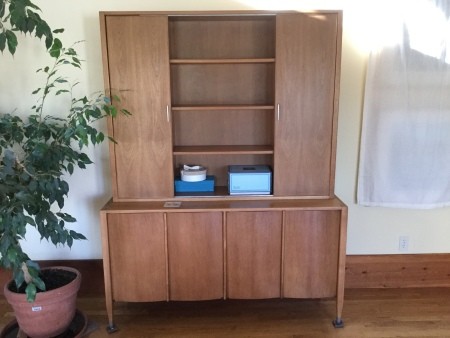 A wooden dining room cabinet.