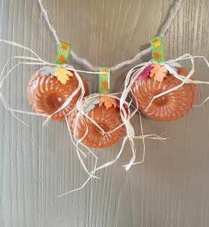 Mini Baking Tin Pumpkins - hanging on a door