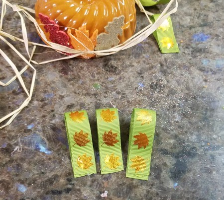 Mini Baking Tin Pumpkins - view of the raffia on the outside, leaves in place and ribbon hangers cut and glued to self