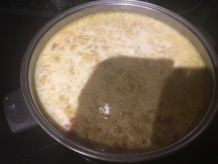 Adding cream to the sausage mixture.