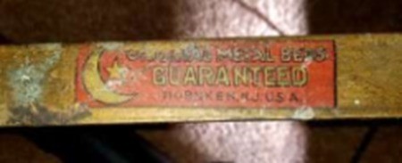 A label on a brass bed.