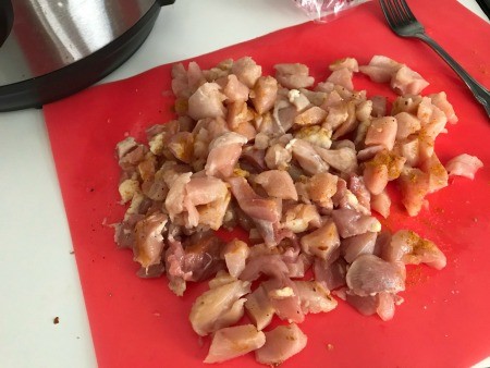 Chopped chicken breast on a cutting board.