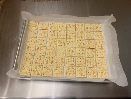 Halloween Saltine Toffee - saltines arranged on parchment paper lined pan
