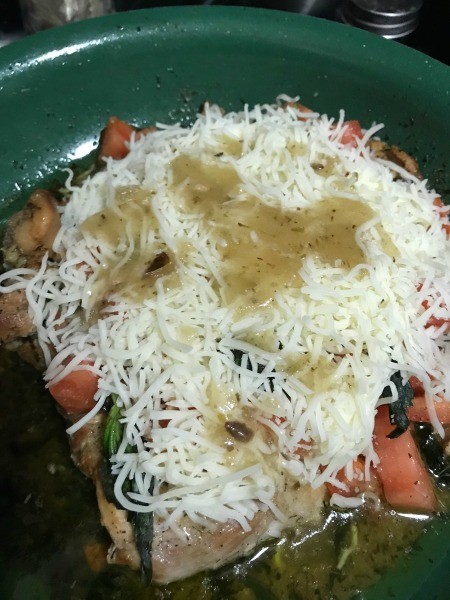 Adding dressing to the caprese mixture.