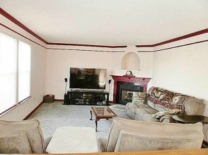 A living room with light colored furniture.