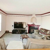 A living room with light colored furniture.