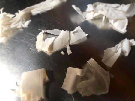 Pieces of phyllo dough on a cookie sheet.