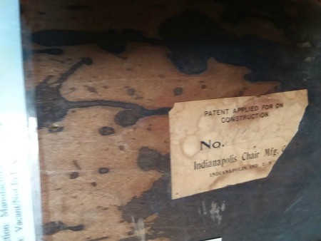 The label on the bottom of a wooden table.