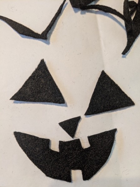 Halloween Pumpkin Planter - black felt cut into pieces for the face, with the mouth finished