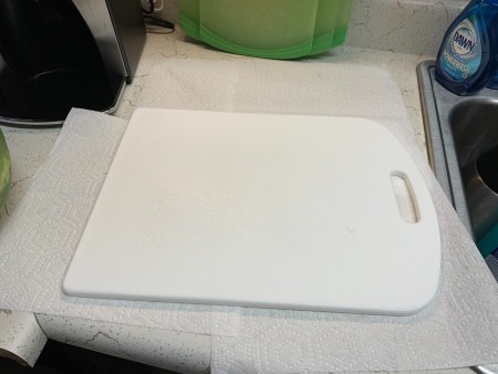 A cutting board on top of paper towels.