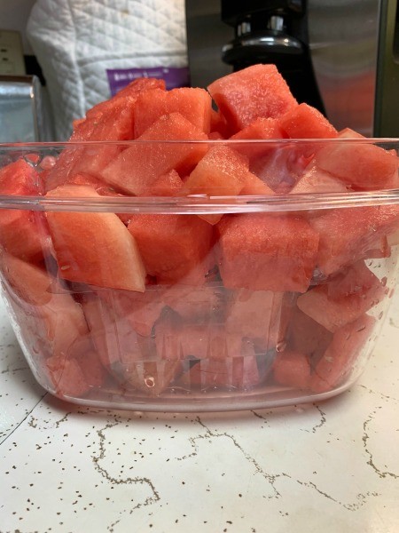 A container full of watermelon chunks.
