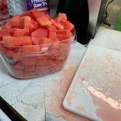 A container full of watermelon chunks.