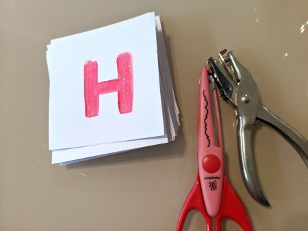 Painted Happy Birthday Banner - fancy scissors and hole punch next to a letter square