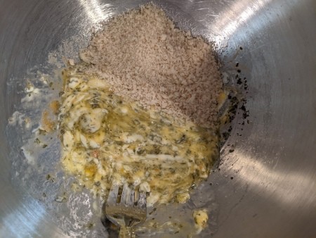 Adding bread crumbs to the egg mixture.