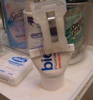 Using a chip clip to close a cut tube of toothpaste.