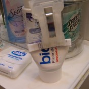 Using a chip clip to close a cut tube of toothpaste.