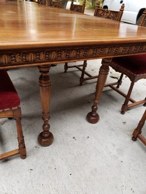 An ornately carved side to a dining room table.