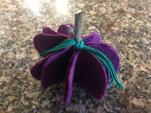 Five Minute Felt Pumpkin - finished purple pumpkin with teal embroidery floss tied to twig stem