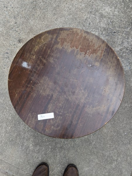 The top of a round wooden table.