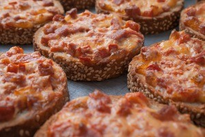 Slices of bread topped with pepperoni and cheese.