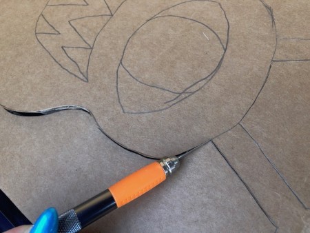 Cardboard Window Monster - cut out the monster using your X-acto knife