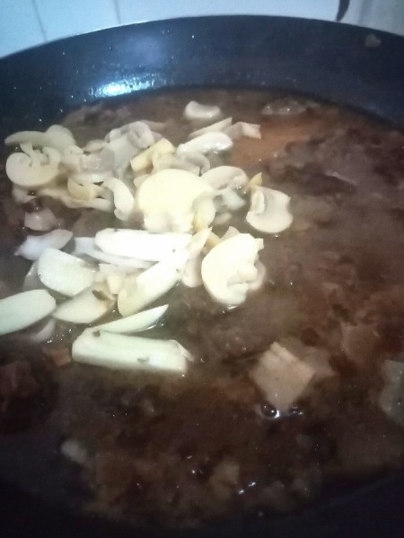 Adding vegetables to the frying pan.