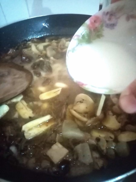 Adding a cornstarch mixture to the pan.