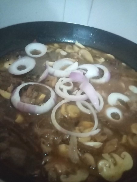 Cooking the ingredients together in a frying pan.