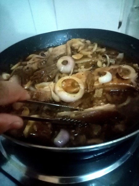 Cooking the ingredients together in a frying pan.