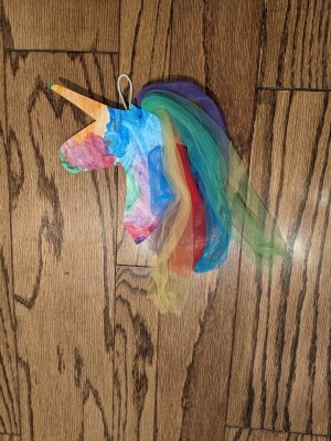 Rainbow Unicorn Wall Decoration - unicorn lying on a wood floor