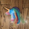 Rainbow Unicorn Wall Decoration - unicorn lying on a wood floor