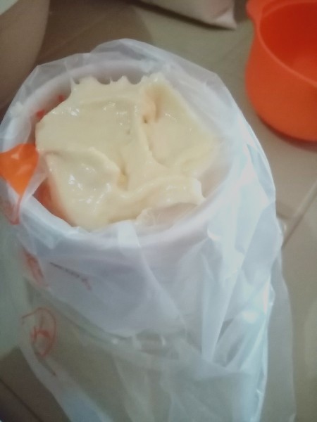 Putting pancake batter in a piping bag.