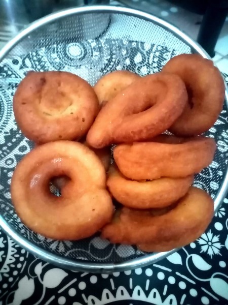 A basket of freshly fried doughnuts.